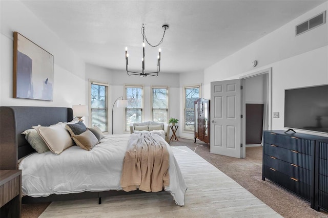 carpeted bedroom with visible vents and a notable chandelier