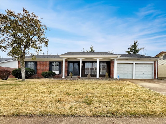 ranch-style home featuring a front lawn and a garage