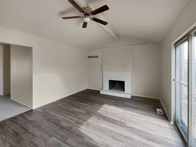 unfurnished living room featuring ceiling fan, light hardwood / wood-style flooring, a fireplace, and vaulted ceiling