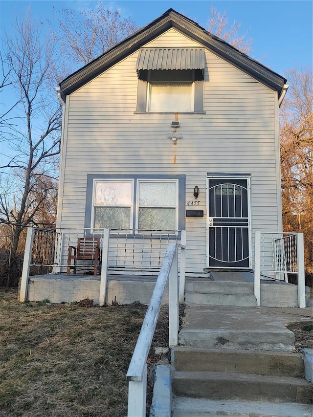 back of property with covered porch