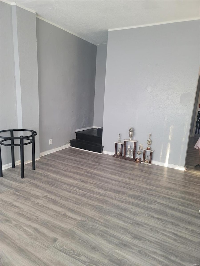 living room featuring wood-type flooring and ornamental molding