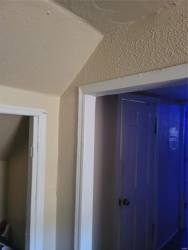 hallway featuring vaulted ceiling