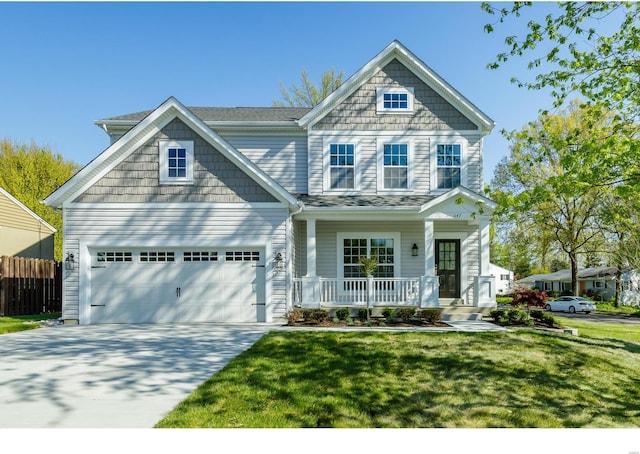 craftsman-style house with a garage, a front lawn, and covered porch