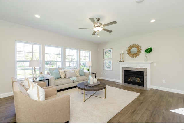 living room with ceiling fan, a fireplace, and dark hardwood / wood-style flooring