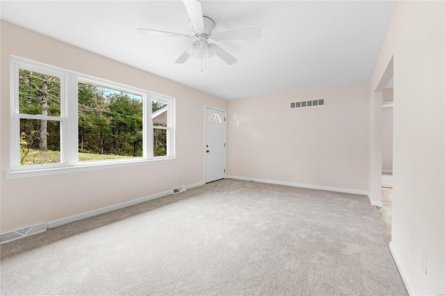 empty room featuring carpet floors and ceiling fan