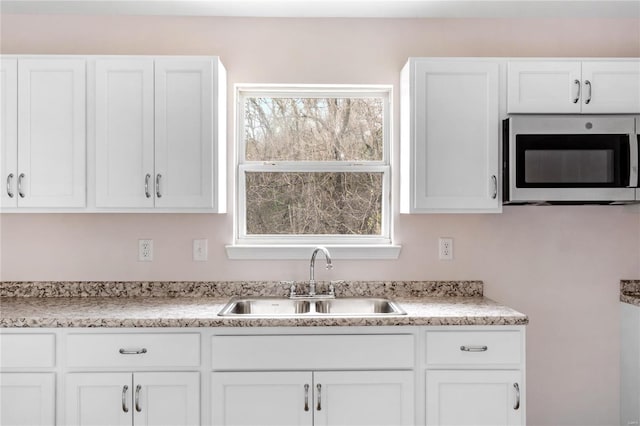 kitchen with white cabinetry and sink