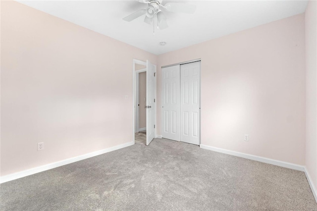 unfurnished bedroom with ceiling fan, light carpet, and a closet