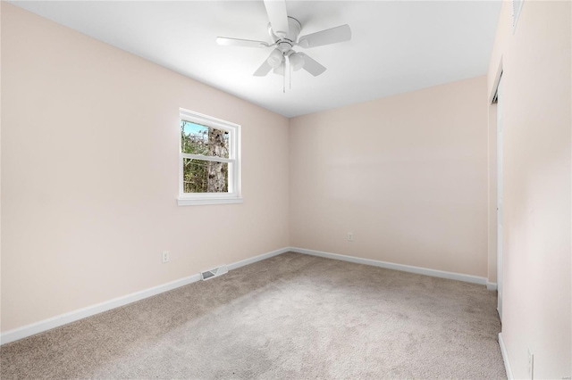 carpeted spare room featuring ceiling fan