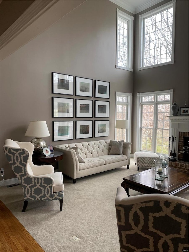 living room with carpet flooring, a fireplace, and a towering ceiling