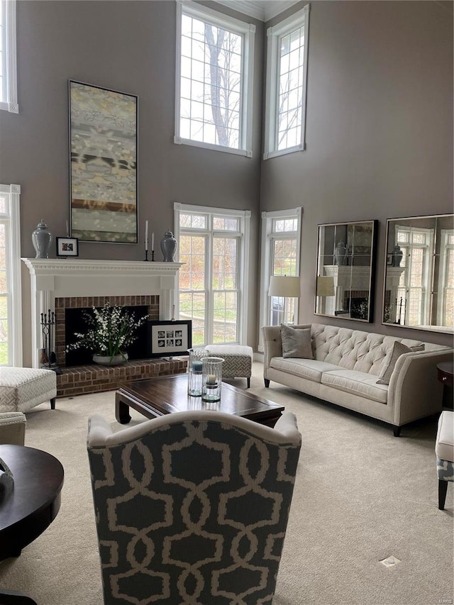 living room with plenty of natural light, a towering ceiling, carpet floors, and a fireplace