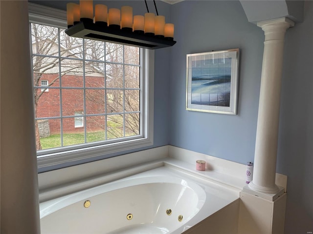 bathroom featuring a bathing tub and ornate columns