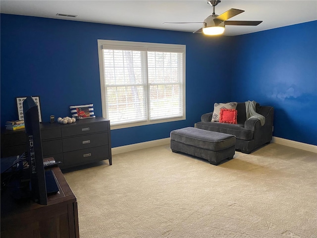 sitting room featuring light carpet and ceiling fan