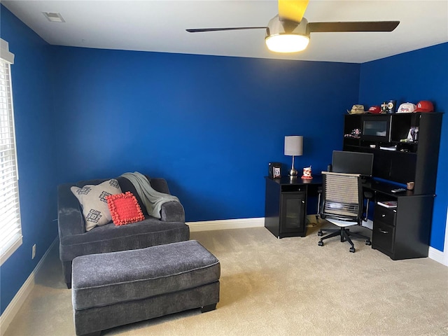 office space with ceiling fan and light carpet