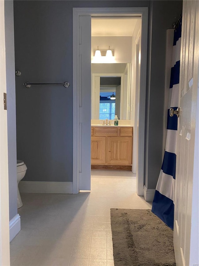 bathroom with vanity, tile flooring, and toilet