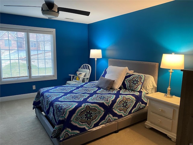 bedroom with light carpet and ceiling fan