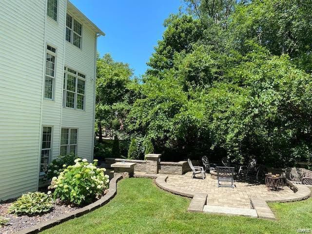 view of yard with an outdoor fire pit and a patio area