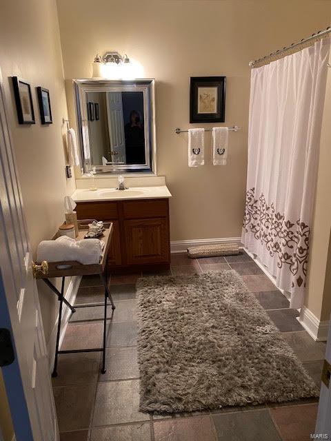 bathroom with vanity with extensive cabinet space and tile flooring