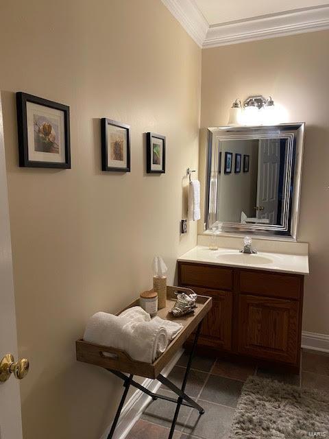 bathroom with ornamental molding, tile floors, and vanity