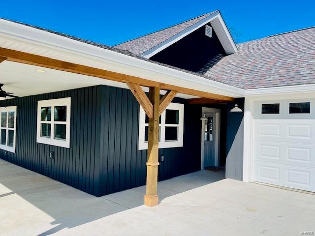 view of home's exterior featuring ceiling fan and a garage