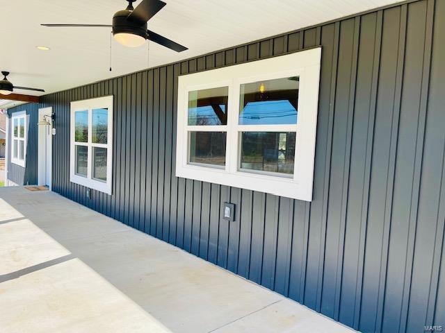 view of side of property featuring ceiling fan and a patio