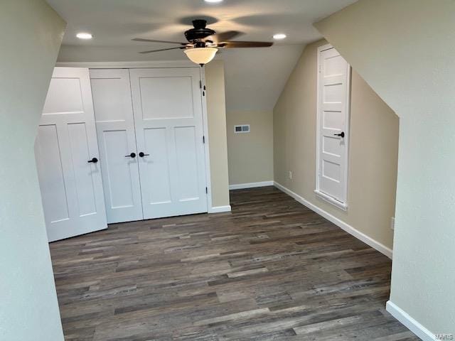 additional living space featuring dark hardwood / wood-style floors, ceiling fan, and vaulted ceiling