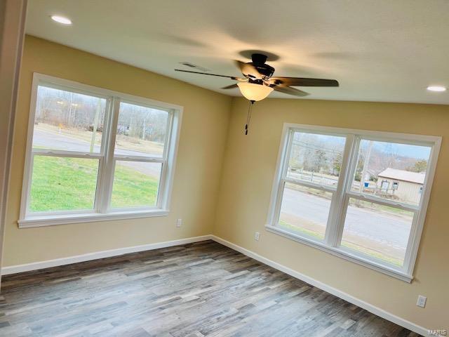 empty room with ceiling fan and dark hardwood / wood-style floors