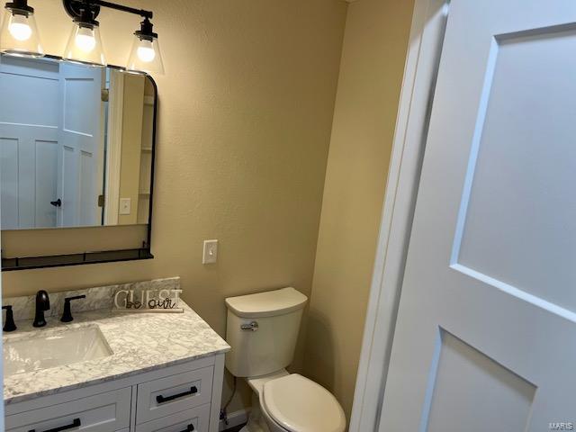 bathroom with toilet and vanity