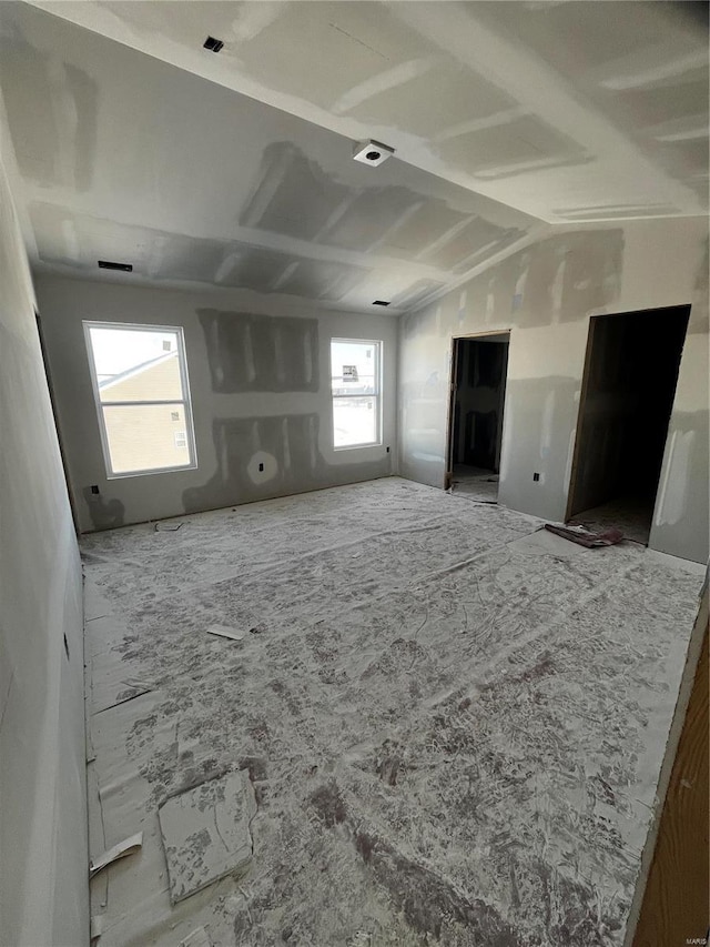 empty room featuring lofted ceiling