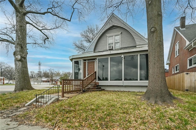 back of house featuring a sunroom