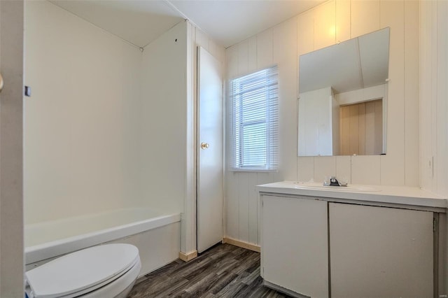 full bathroom with bathtub / shower combination, toilet, hardwood / wood-style flooring, and vanity