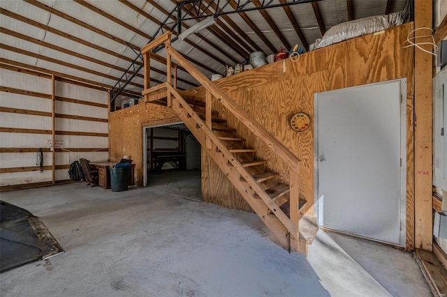 interior space featuring concrete flooring and lofted ceiling