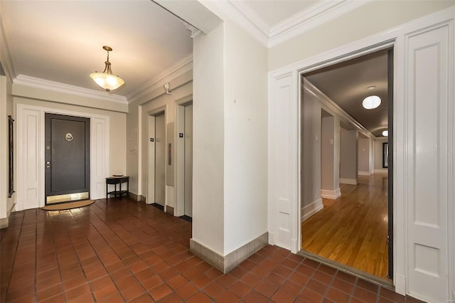 corridor featuring dark tile patterned flooring, elevator, crown molding, and baseboards