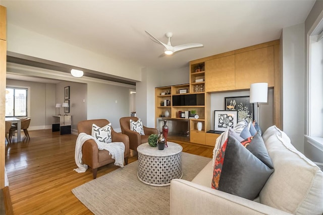 living room with ceiling fan and hardwood / wood-style floors