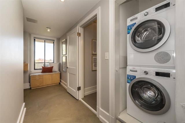 laundry area featuring stacked washer / drying machine