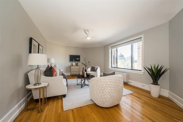 living room featuring ceiling fan and light hardwood / wood-style flooring