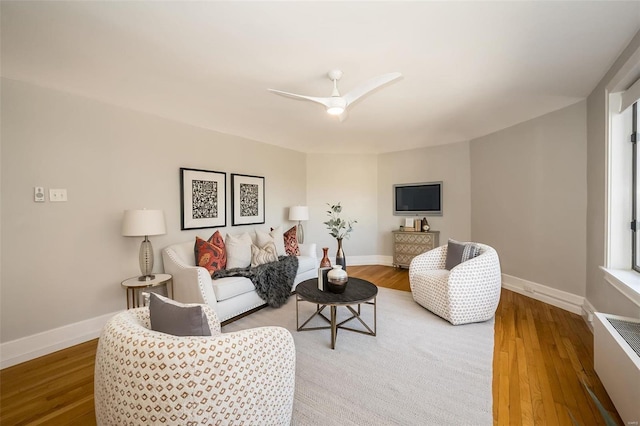 living room with light hardwood / wood-style floors and ceiling fan