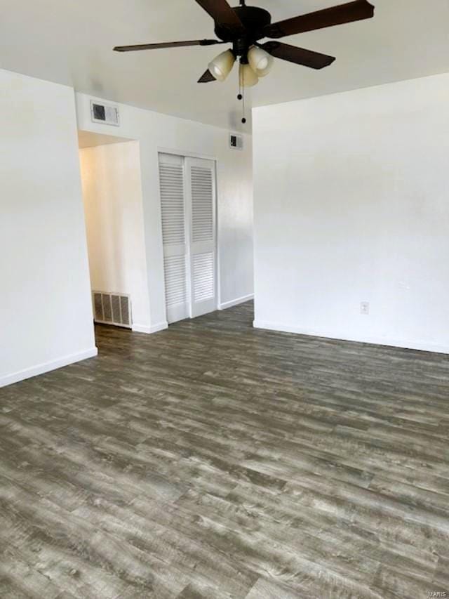 spare room featuring ceiling fan and dark wood-type flooring