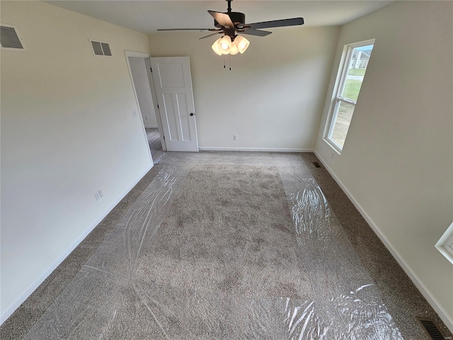 unfurnished room with ceiling fan and carpet flooring