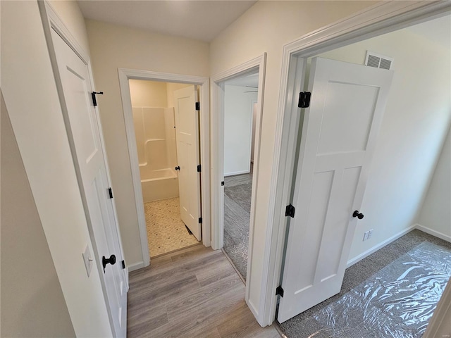 corridor featuring light hardwood / wood-style floors