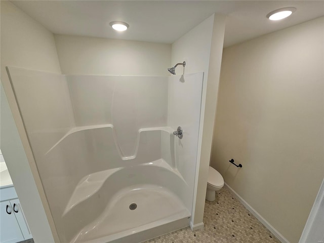 bathroom with toilet, a shower, and tile patterned flooring