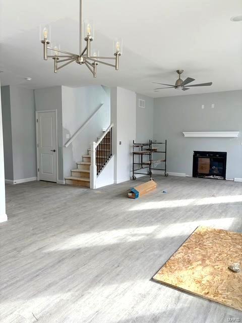 unfurnished living room with hardwood / wood-style flooring and ceiling fan