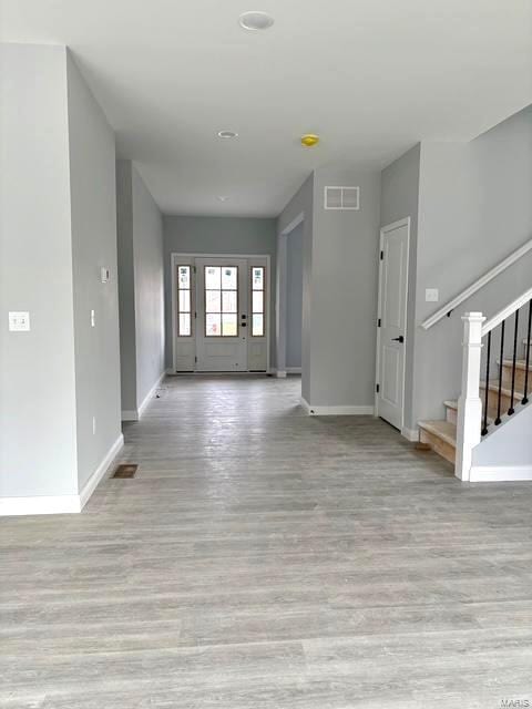 foyer entrance with light wood-type flooring