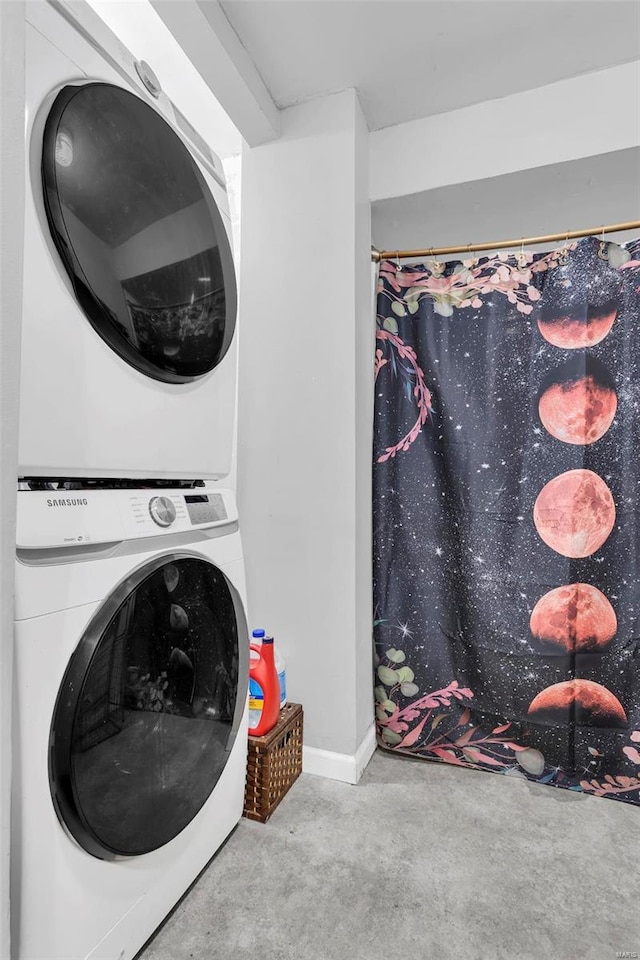 clothes washing area with stacked washer and dryer