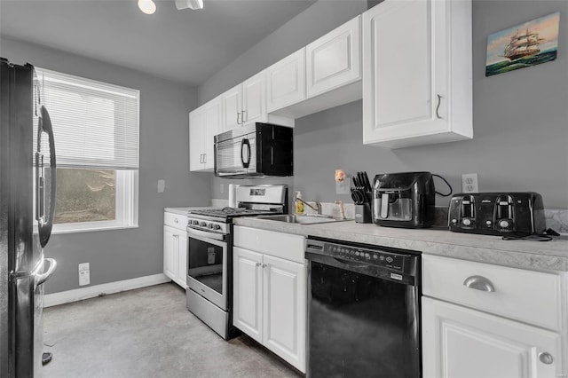 kitchen with black appliances, white cabinets, and sink