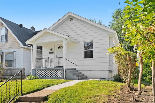 bungalow-style home with a front lawn