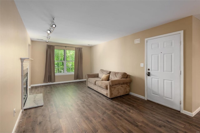 interior space featuring rail lighting and dark hardwood / wood-style floors