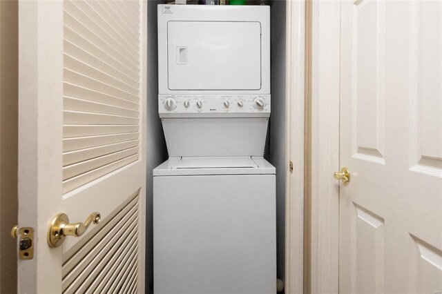 washroom featuring stacked washer and dryer