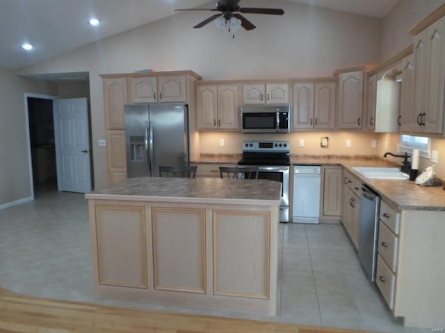 kitchen with stainless steel appliances, a center island, light tile floors, ceiling fan, and sink