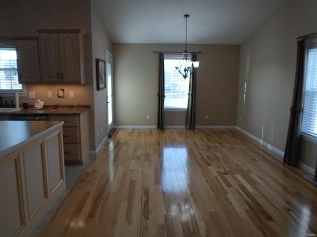 kitchen featuring an inviting chandelier, light hardwood / wood-style floors, and pendant lighting