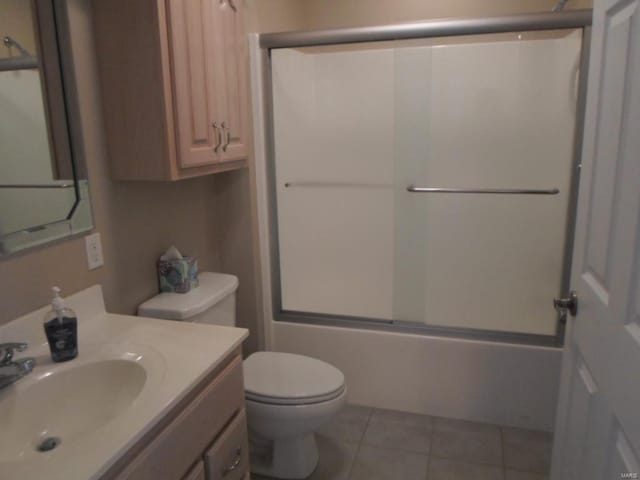 full bathroom with shower / bath combination with glass door, tile flooring, toilet, and vanity